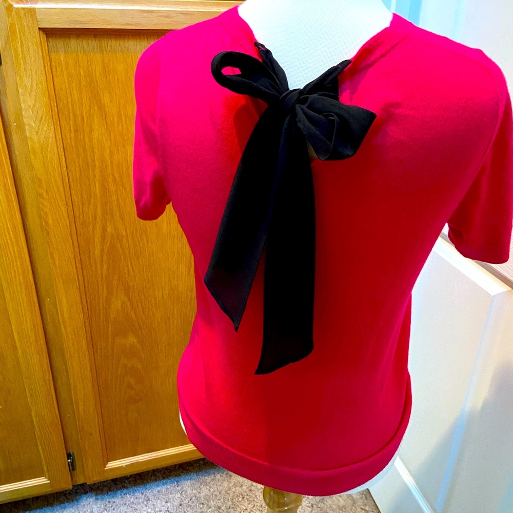 Adorable hot pink sweater with black bow on back